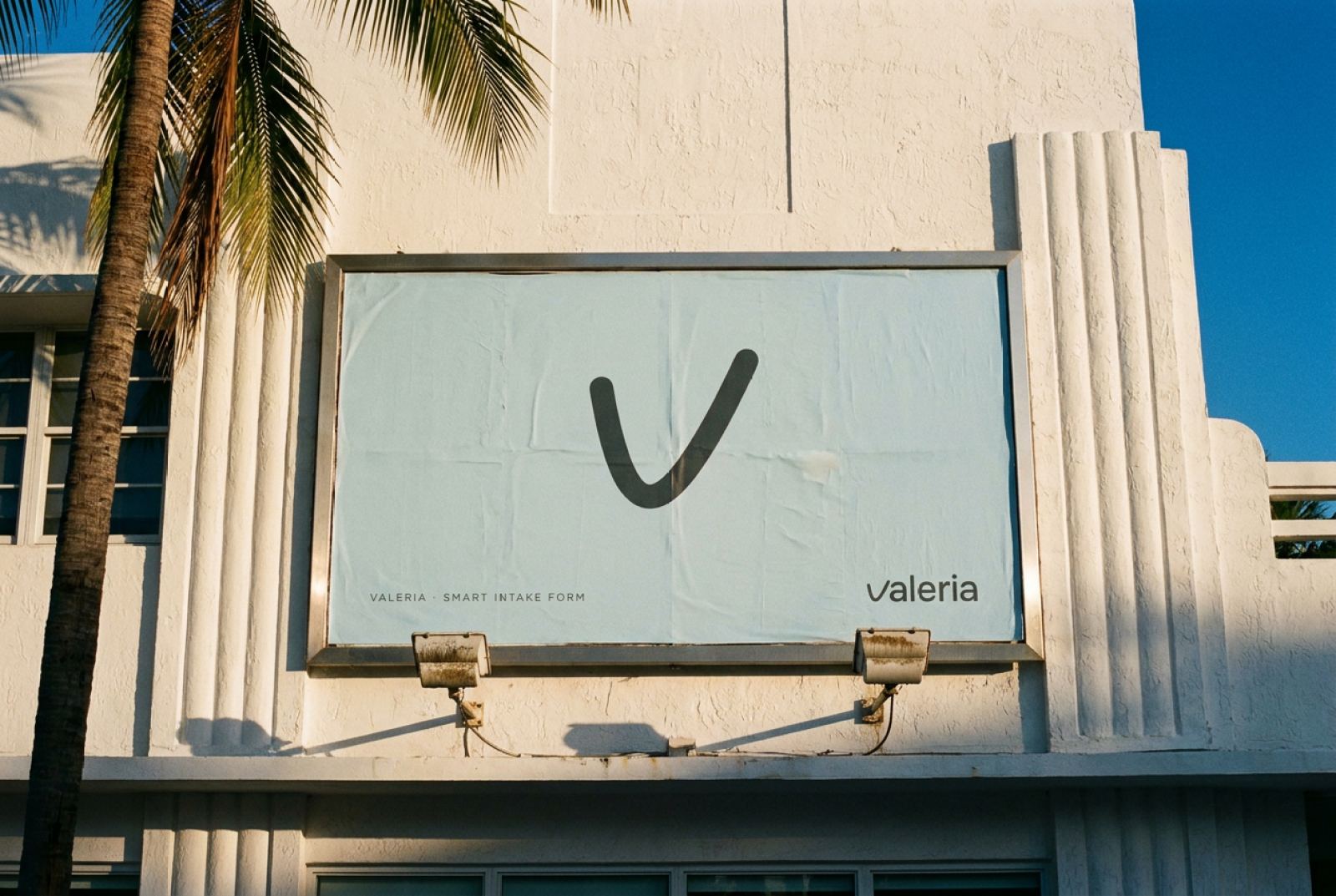 The VALERIA thread mark on a Seafoam billboard on a white Art Deco building under palms in Miami